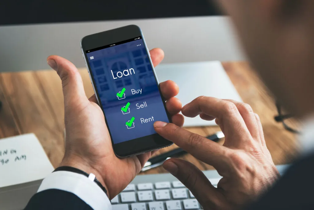 Person using a mobile banking application on a smartphone to manage financial services.